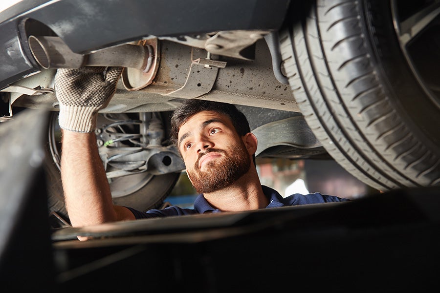 Technician working under vehicle